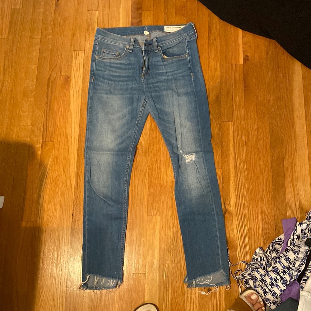 Rag & Bone skinny light blue wash jean with one rip on left knee.